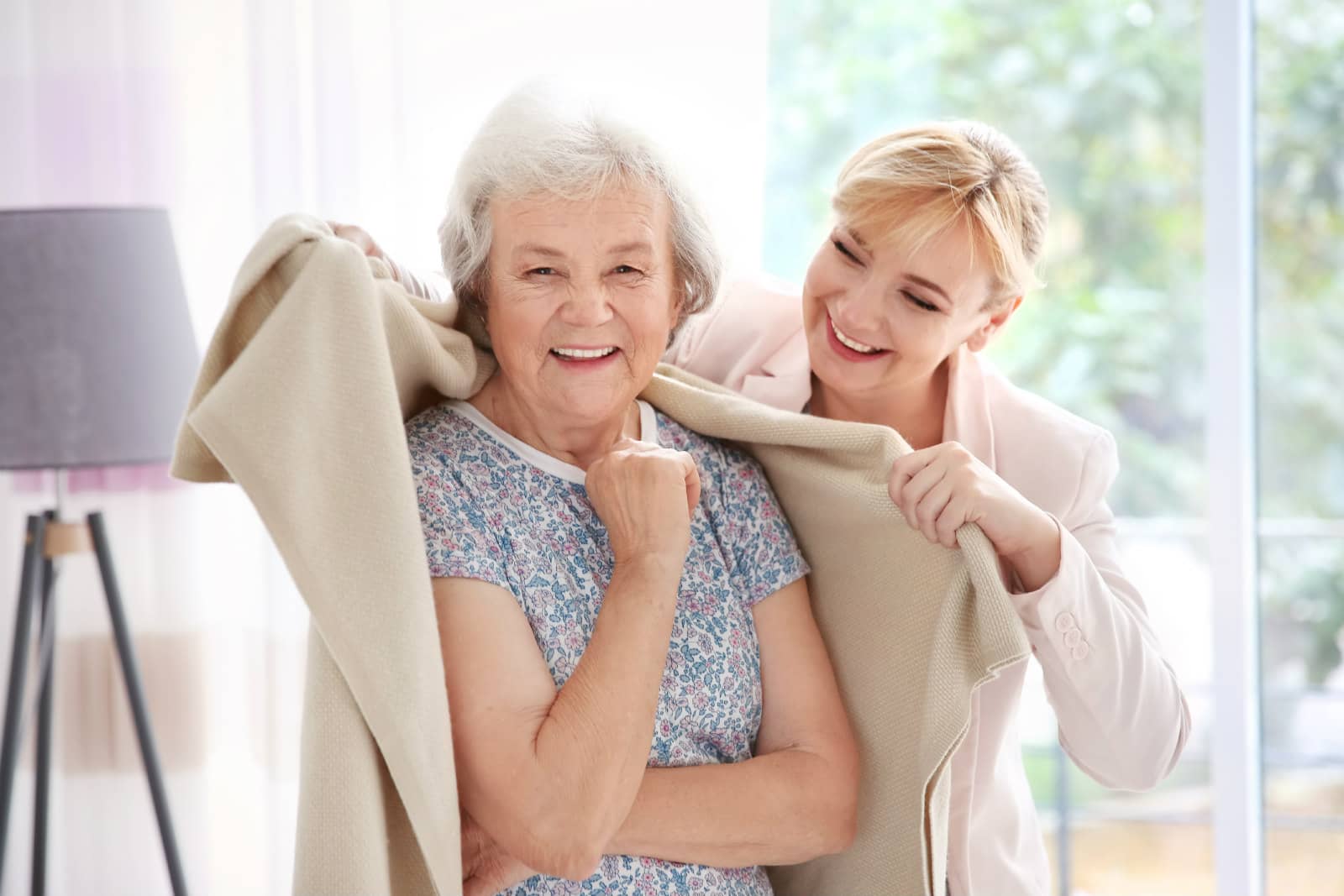 Live In carer helping an elderly woman get dressed