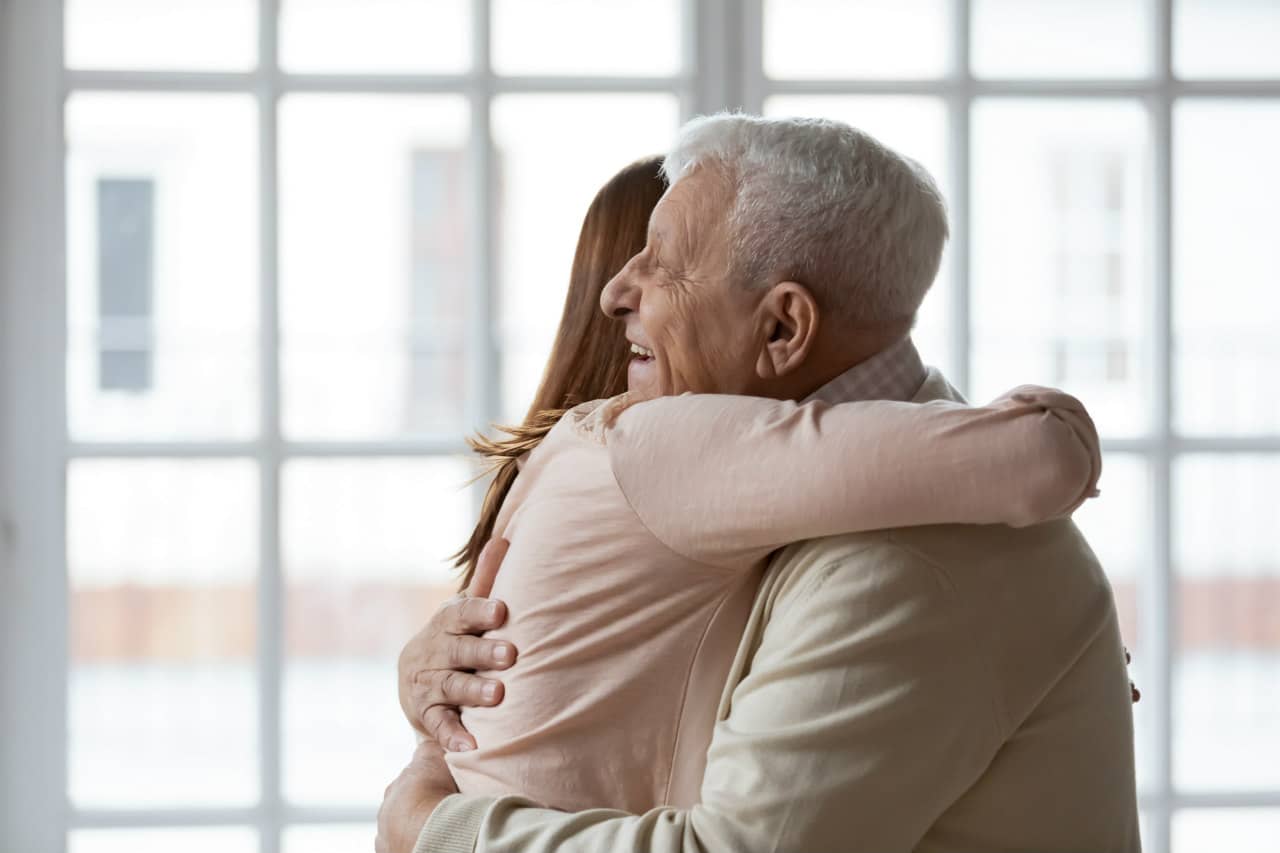 Elderly father embracing his daughter on fathers day